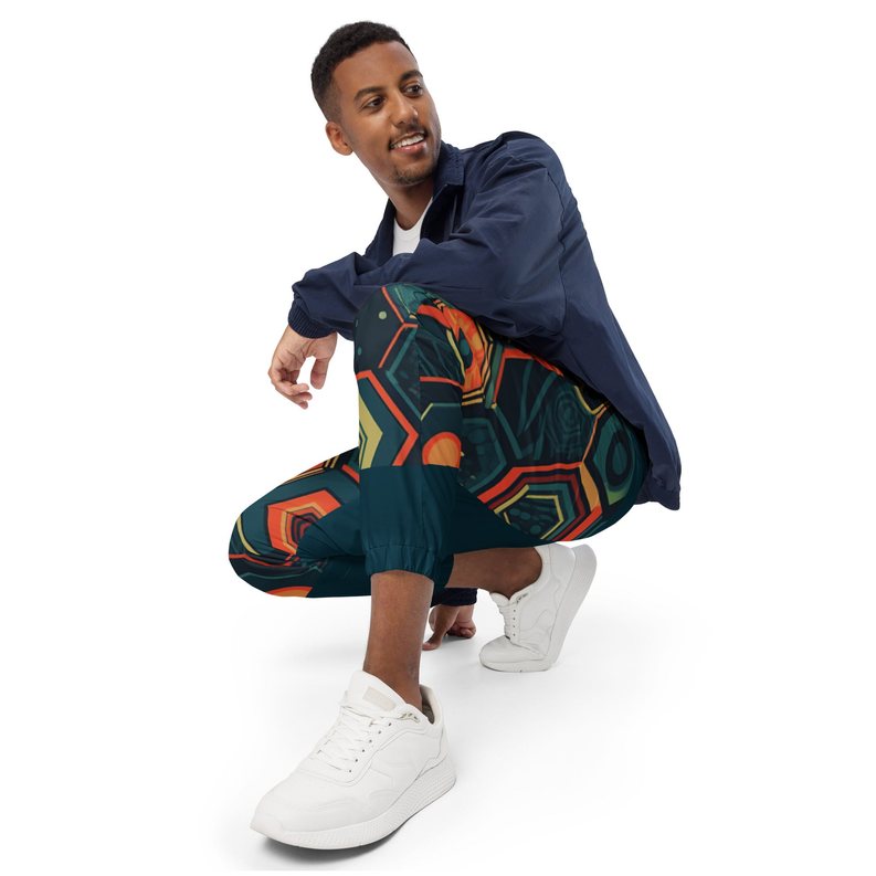 Multicolor geometric printed track pants on teal base with elastic waistband and cuffs