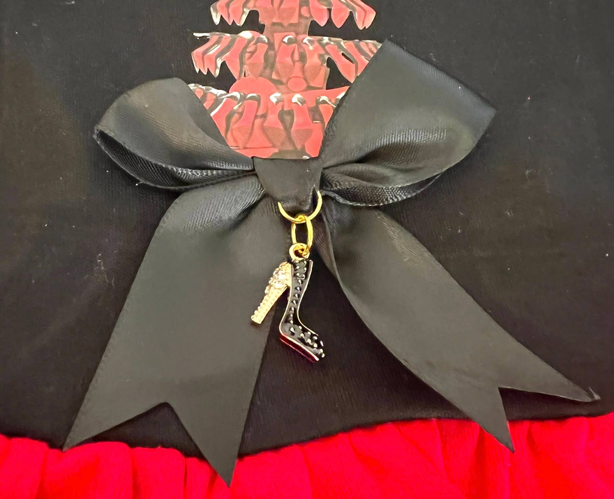 Black dog dress with oversized bow and dangling charm on a red skirt
