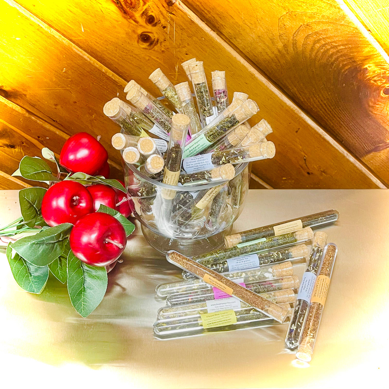Assorted labeled tea test tubes in clear display holder