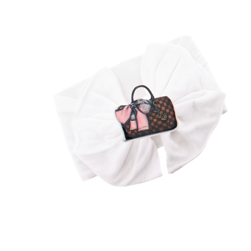 White fabric headband with brown check patterned bow and small charm detail