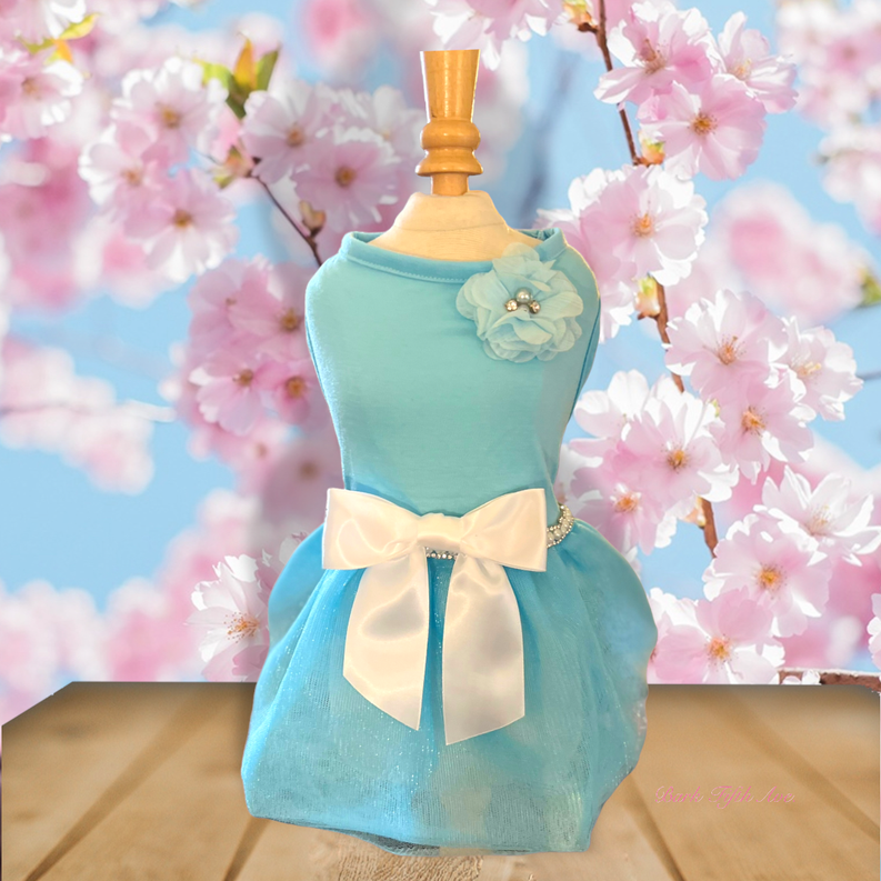 Teal sleeveless dress with large cream bow and rosette flower detail at shoulder