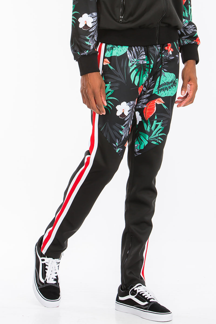 Black printed joggers with tropical leaf/bird pattern and red-white side stripe