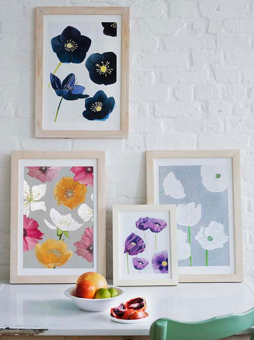 Three framed floral art prints: navy, pink, and white blooms