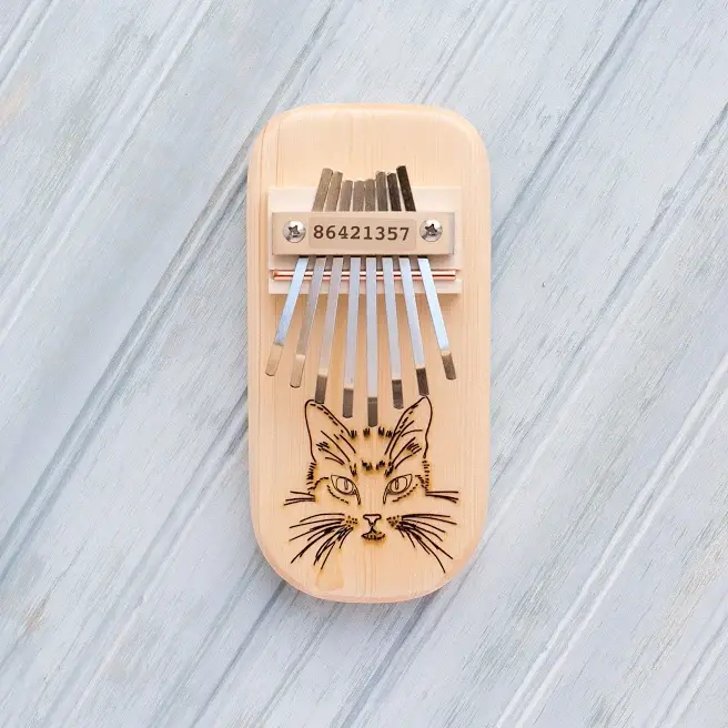 Cat engraved thumb piano with wooden case and metal tines