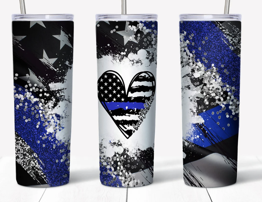 Stainless steel tumbler with black, white, and blue geometric glitter graphic