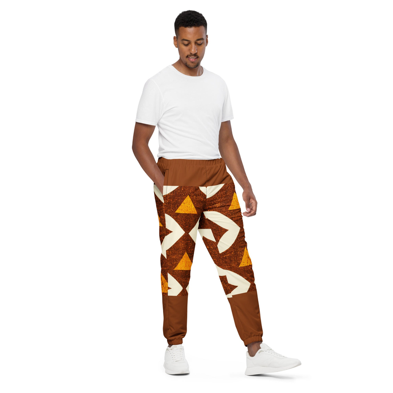 Brown track pants with cream and orange geometric print, relaxed fit on model