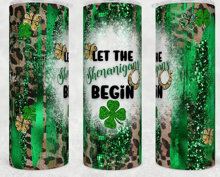 Stainless steel tumbler with green glitter shamrock and “LET THE SHENANIGANS BEGIN”