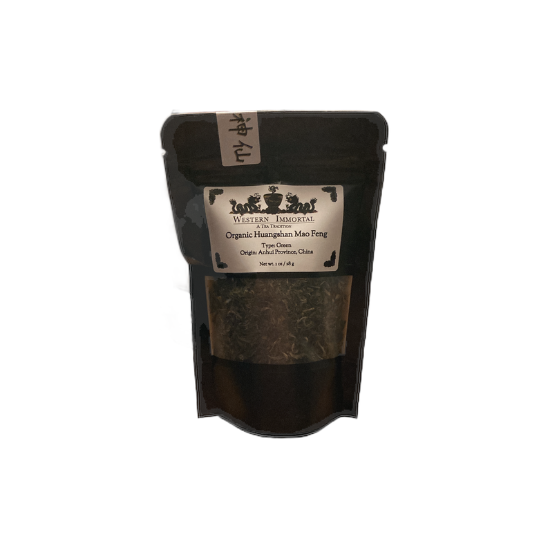 Western Immortal organic tea pouch with label, dark green loose tea inside