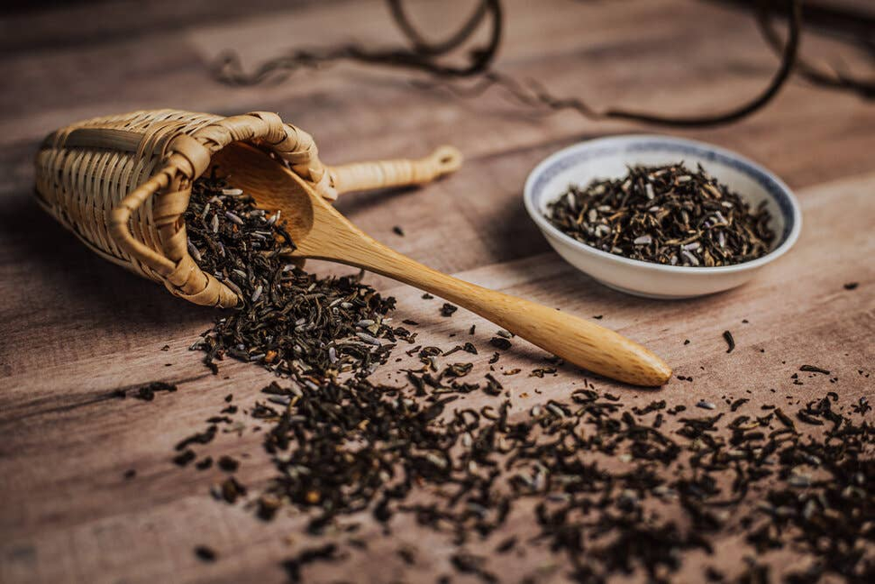 Organic lavender herb dried leaves with wooden scoop and small bowl