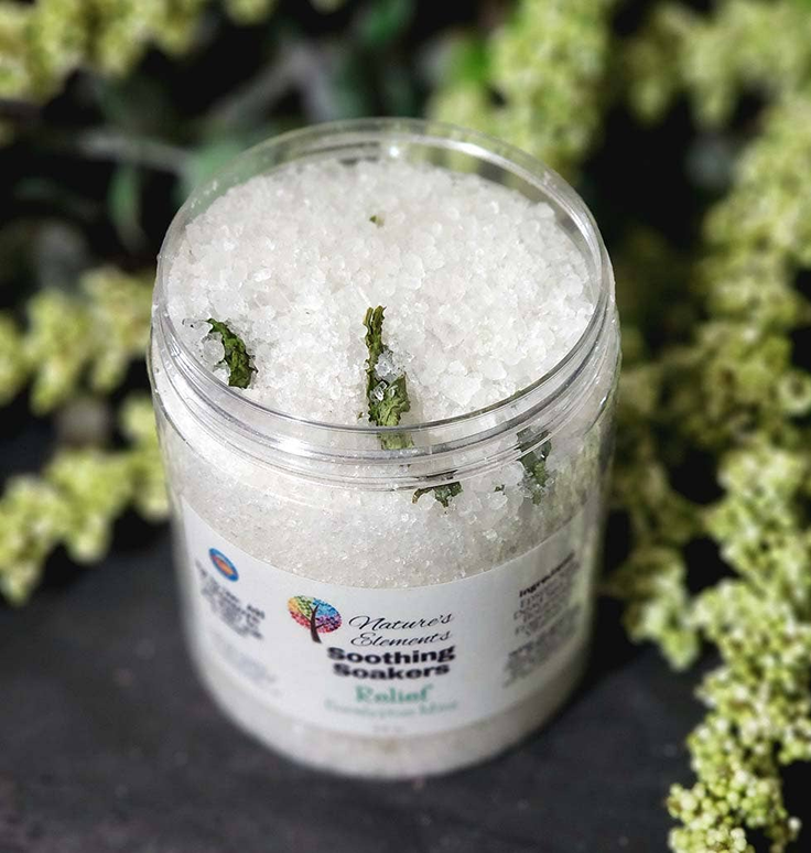 Bath soak jar with white crystals and green herb pieces, Relax scent, clear screw-top