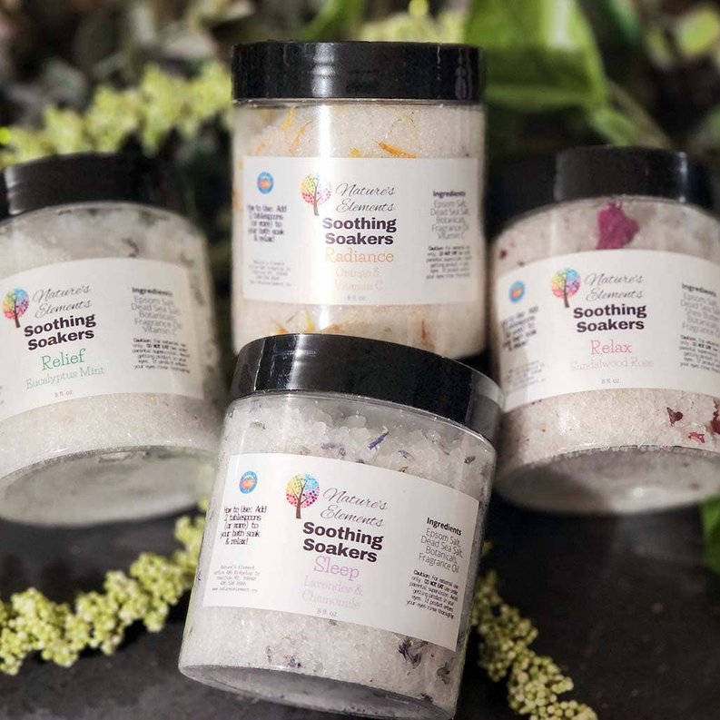 Set of bath soak jars with white crystals and flower petals, clear lids