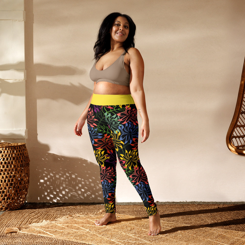 Floral yoga leggings with yellow waistband; multicolor tropical flower print on dark fabric.