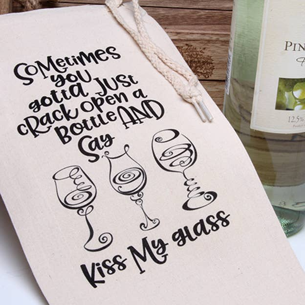 Cream wine tote bag front, black lettering with 'Kiss My glass' and rope handles