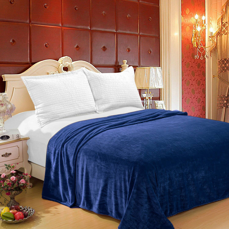 Navy plush flannel bed throw blanket, draped over bed in soft folds