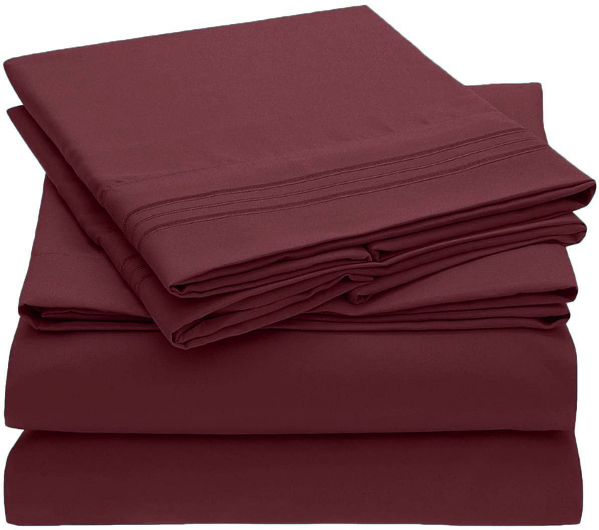 Burgundy sheet set with neatly folded fitted and flat sheets