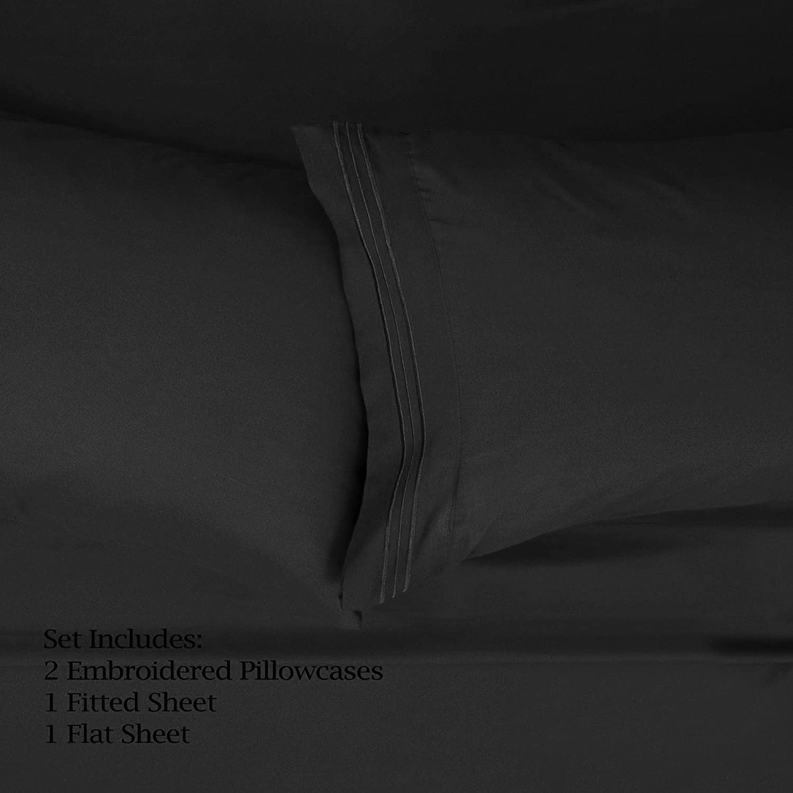 Black sheet set bedding with stitched seams on layered fabric folds