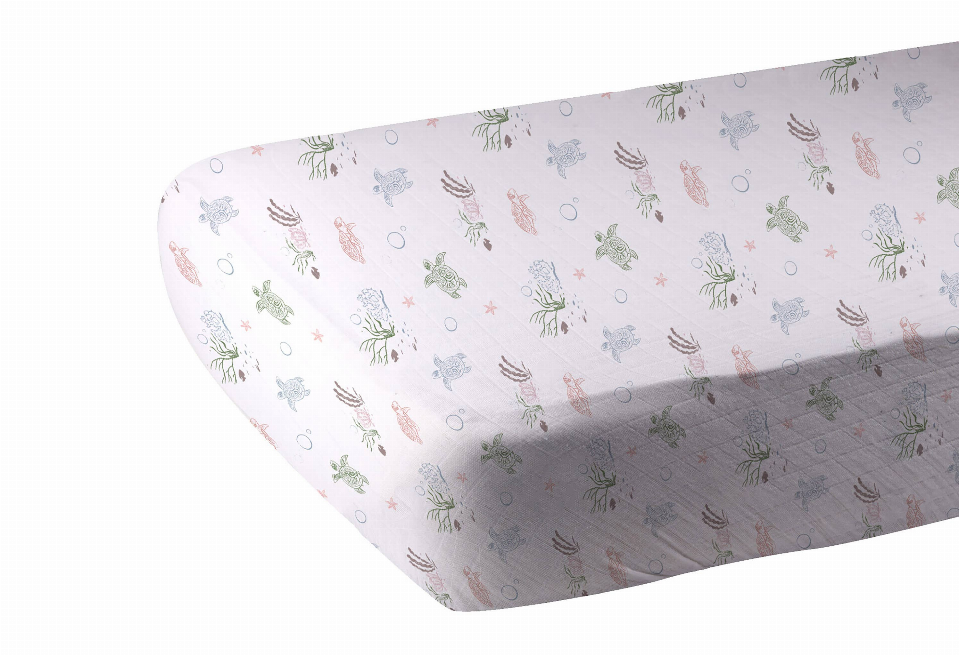 Turtles crib sheet with pastel sea-life print in blue, green, pink on light fabric