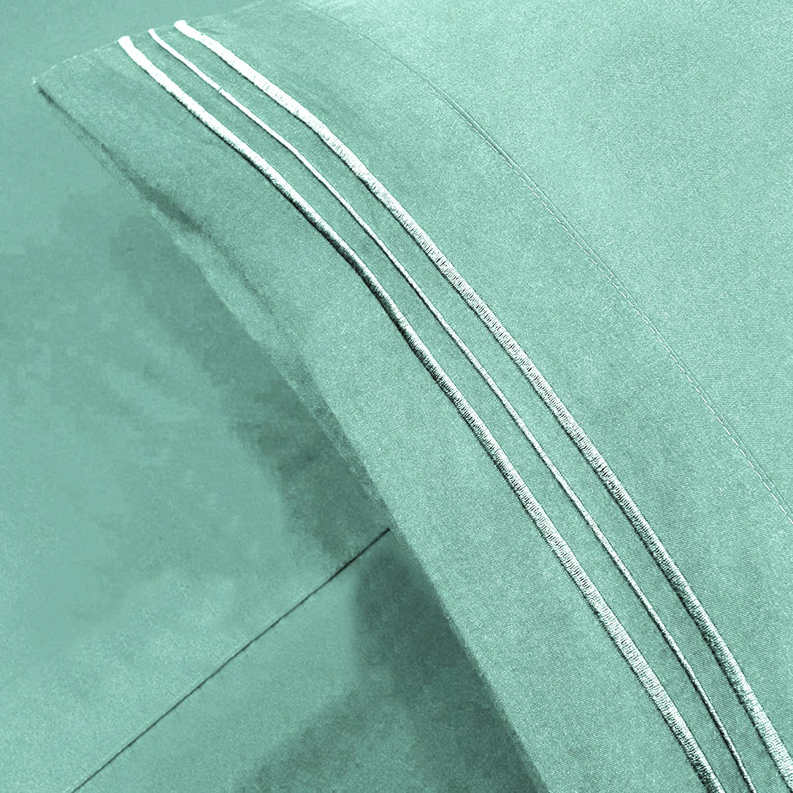 Teal fabric close-up with triple stitched edging and seam detail