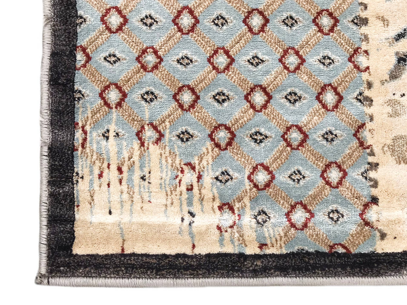Beige ivory rug with blue and red diamond pattern, dark border, and fringe edging