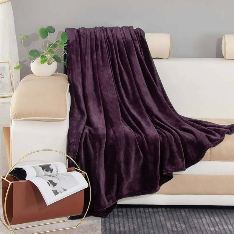 Purple plush throw blanket draped in soft folds, rich velvety texture
