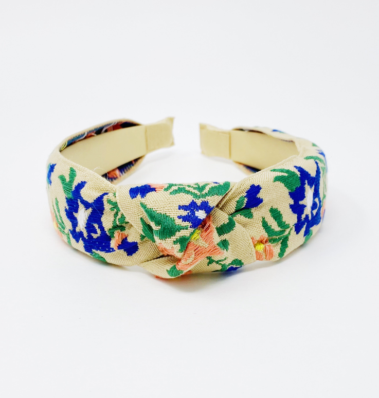 Floral embroidered fabric headband, cream with blue, green, and orange floral pattern