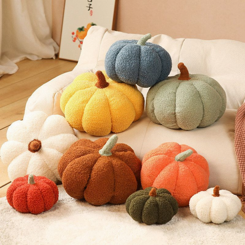 Colorful boucle pumpkin throw pillows in yellow, orange, green, and brown