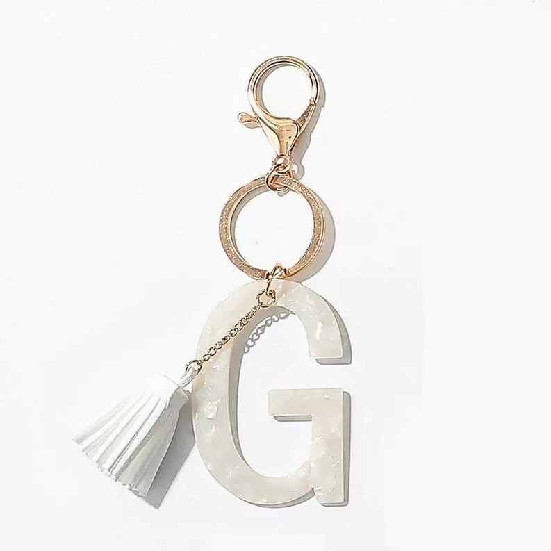 Tasseled initial key chain with gold rings and white letter charm with fringe tassel