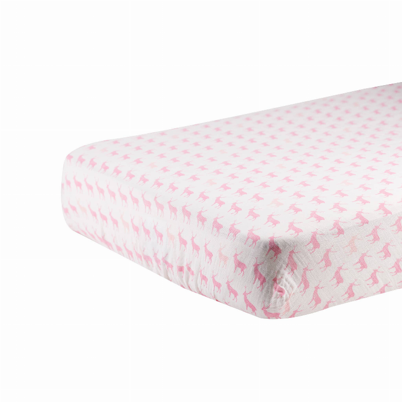 White crib sheet with allover pink deer silhouette pattern, fabric close-up