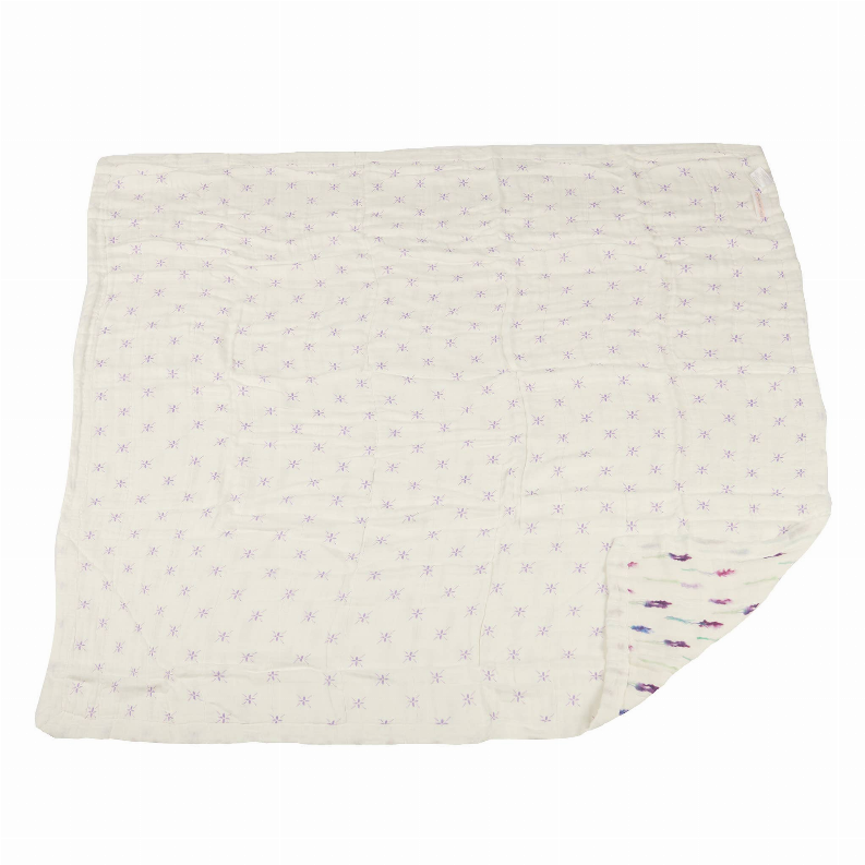 White blanket with small lavender flower-dot pattern, folded corner visible