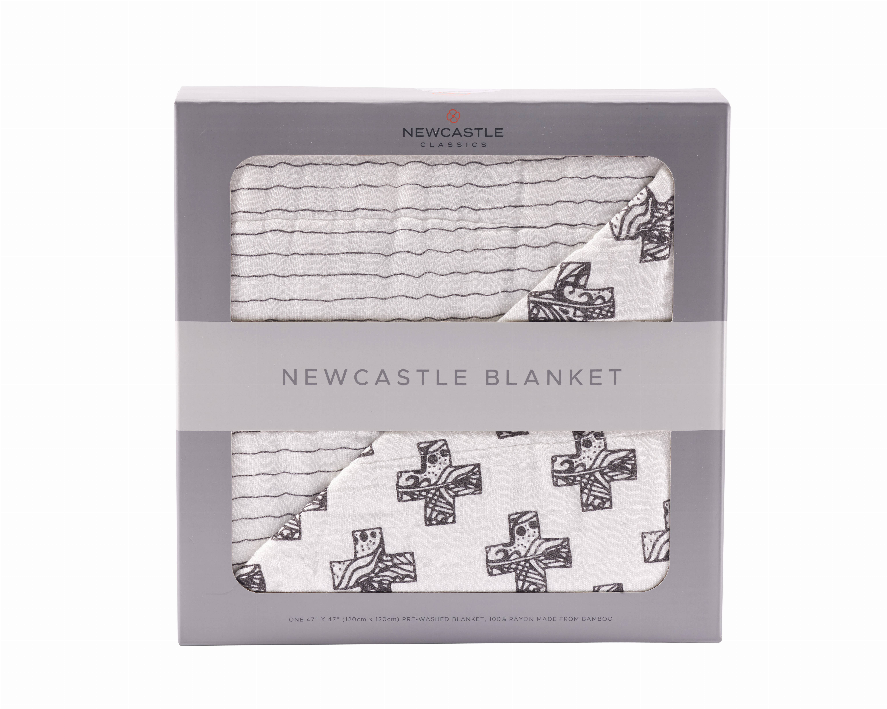 Packaged throw blanket showing light striped quilt and Nordic cross patterned trim