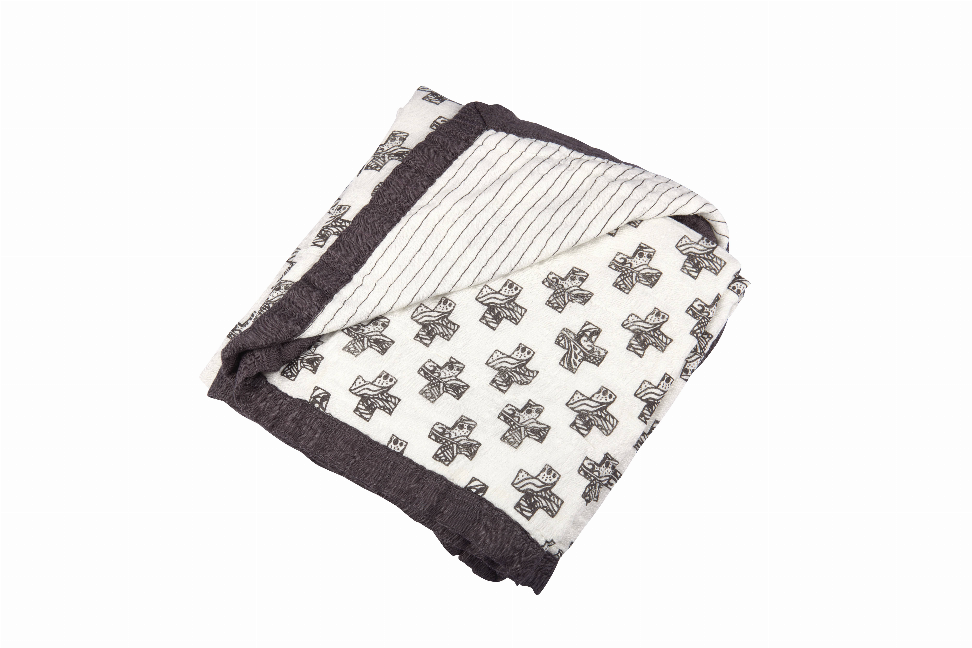 Folded throw blanket with white pencil stripes, dark edge, and Nordic cross print