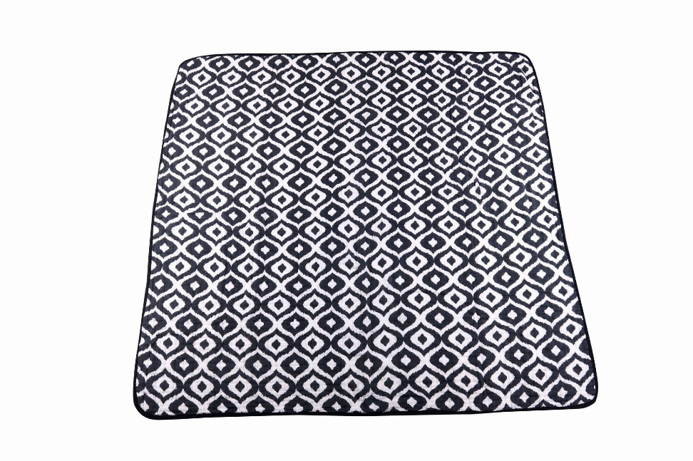 Newcastle blanket folded flat, navy-and-white geometric repeating pattern