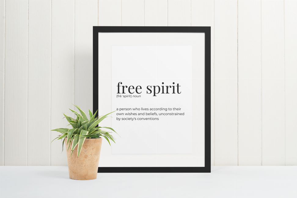 Black-framed wall art print with "free spirit" typography.