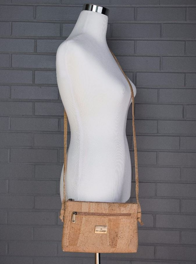 Natural cork crossbody bag with front flap and metal logo, adjustable shoulder strap
