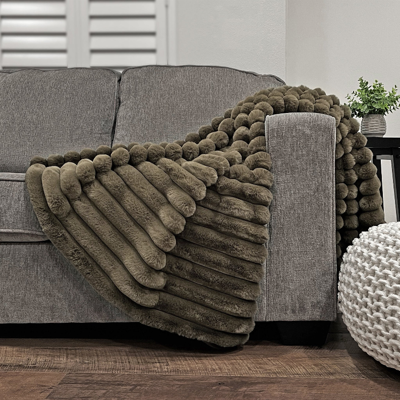 Olive faux fur throw with thick ribbed stripe texture
