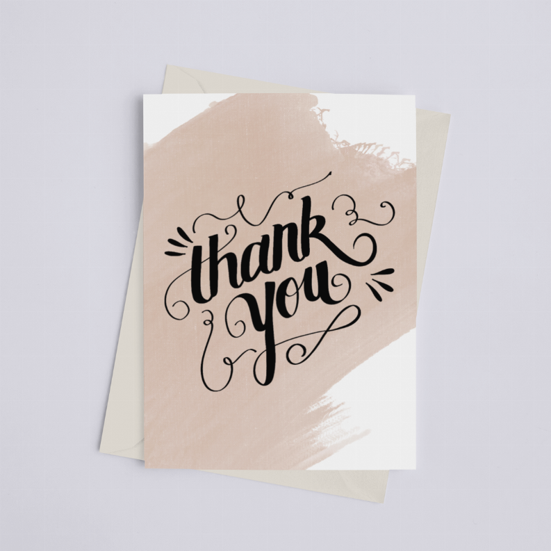 Thank-you watercolor greeting card with black calligraphy text on tan wash, viewed from above