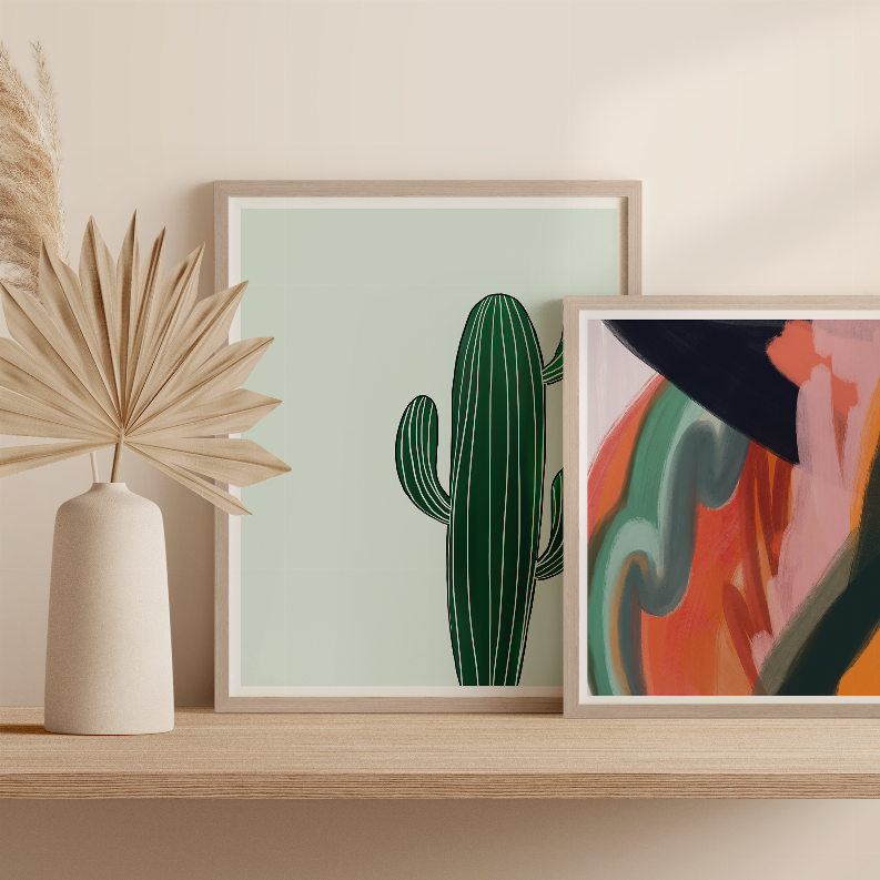 Framed cactus print on wooden shelf with green cactus illustration and mint background