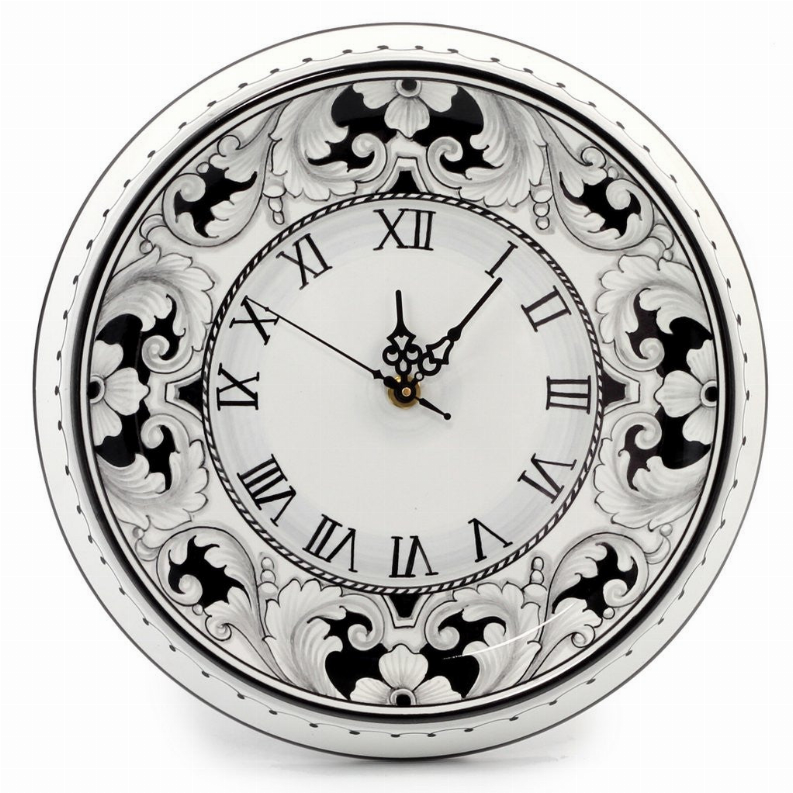 Ornate round wall clock with black-and-white floral design and Roman numeral dial