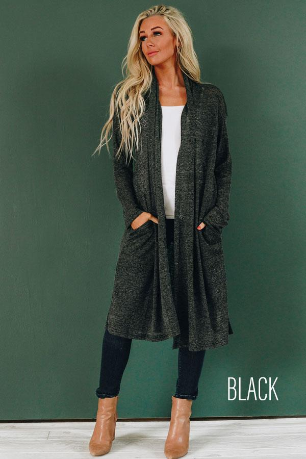 Black slouchy knit cardigan with open front, long sleeves, and side pockets