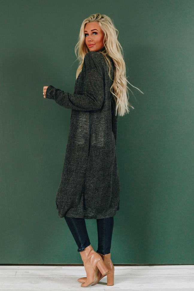 Long black knit cardigan draped open front, long sleeves, and side pockets