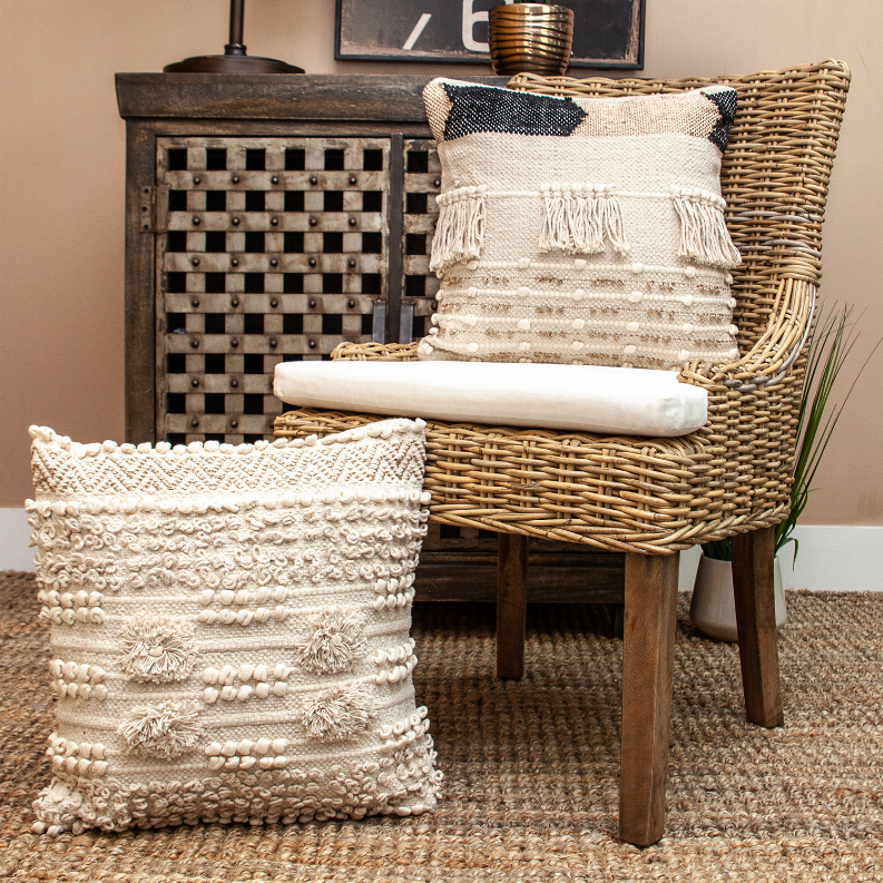 Beige decorative throw pillow with textured stripe pattern and fringe tassels