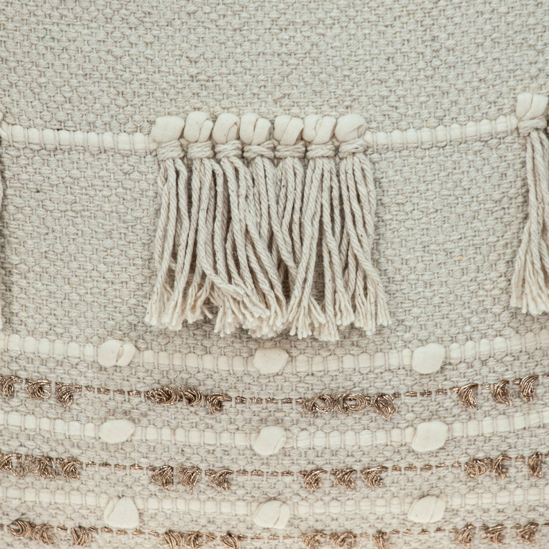 Beige woven pillow fabric with stitched rows, tufts, and tasseled fringe