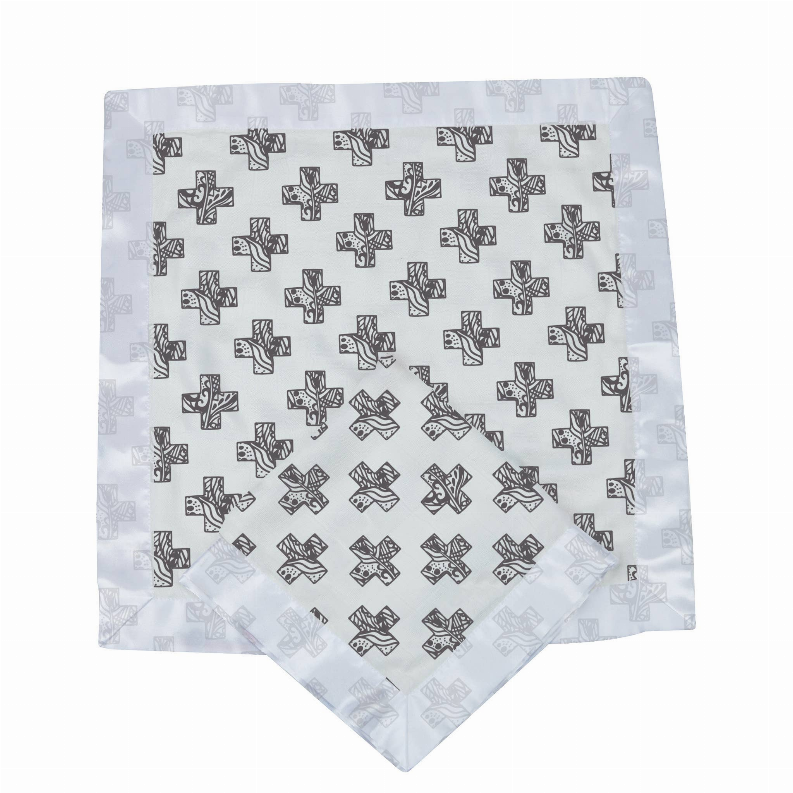 Light blue baby blanket with black cross and Nordic pattern, folded corner