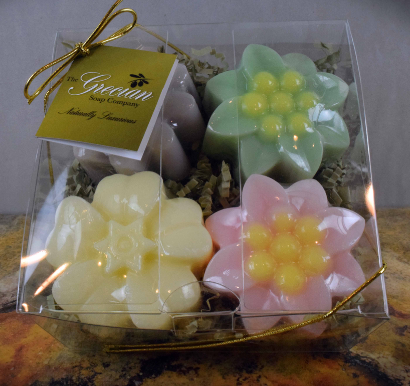 Boxed set of flower-shaped soaps in green, pink, and cream colors in a clear gift box