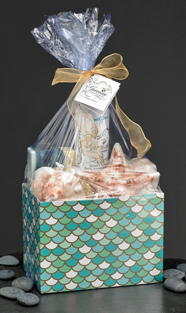 Ocean-themed bath gift set in teal mermaid-scale box, tied with gold ribbon