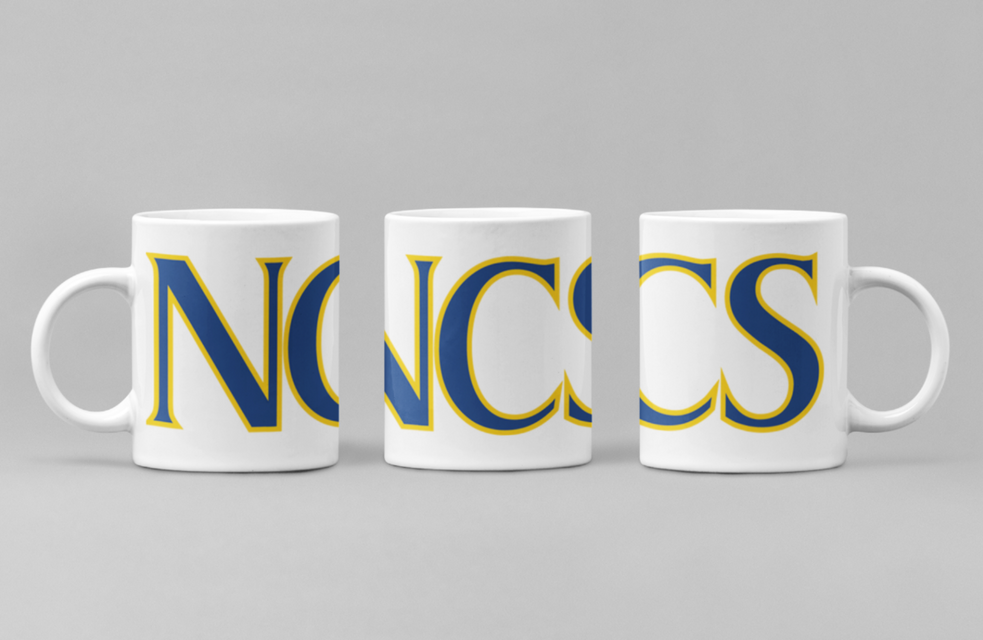 White ceramic coffee mug set with blue and yellow NWC school logo, side handles.