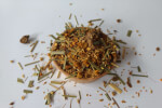 Turmeric ginger tea blend herbs in a loose pile with orange spice shreds