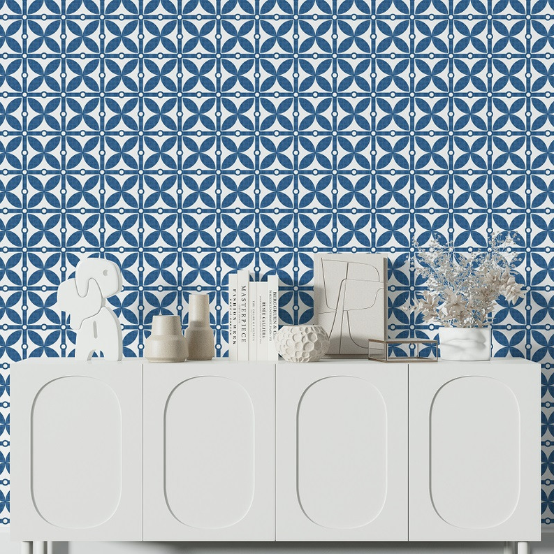 Blue and white medallion wallpaper with repeating lattice pattern behind white cabinet