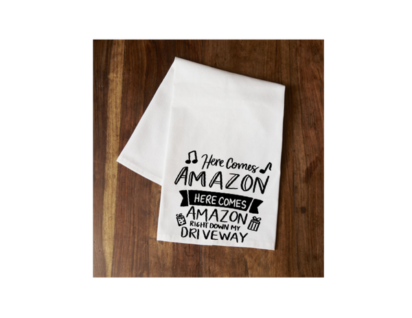 White tea towel with Here Comes Amazon music-note text and Right Down My Driveway