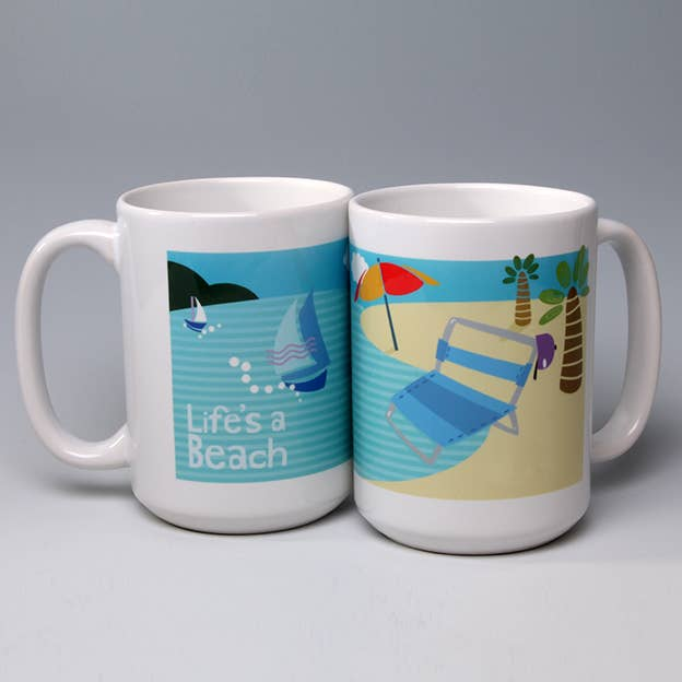 White ceramic beach mug with Life's a Beach graphic, palm trees, sailboats, and umbrellas